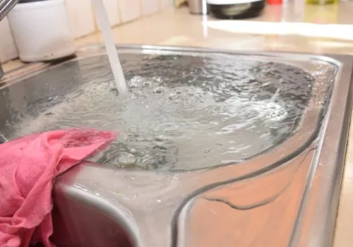 A sink that’s running and overflowing, a plumbing emergency that Warner Mechanical can handle.